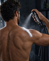 Man spraying Regenex mousse on his upper back